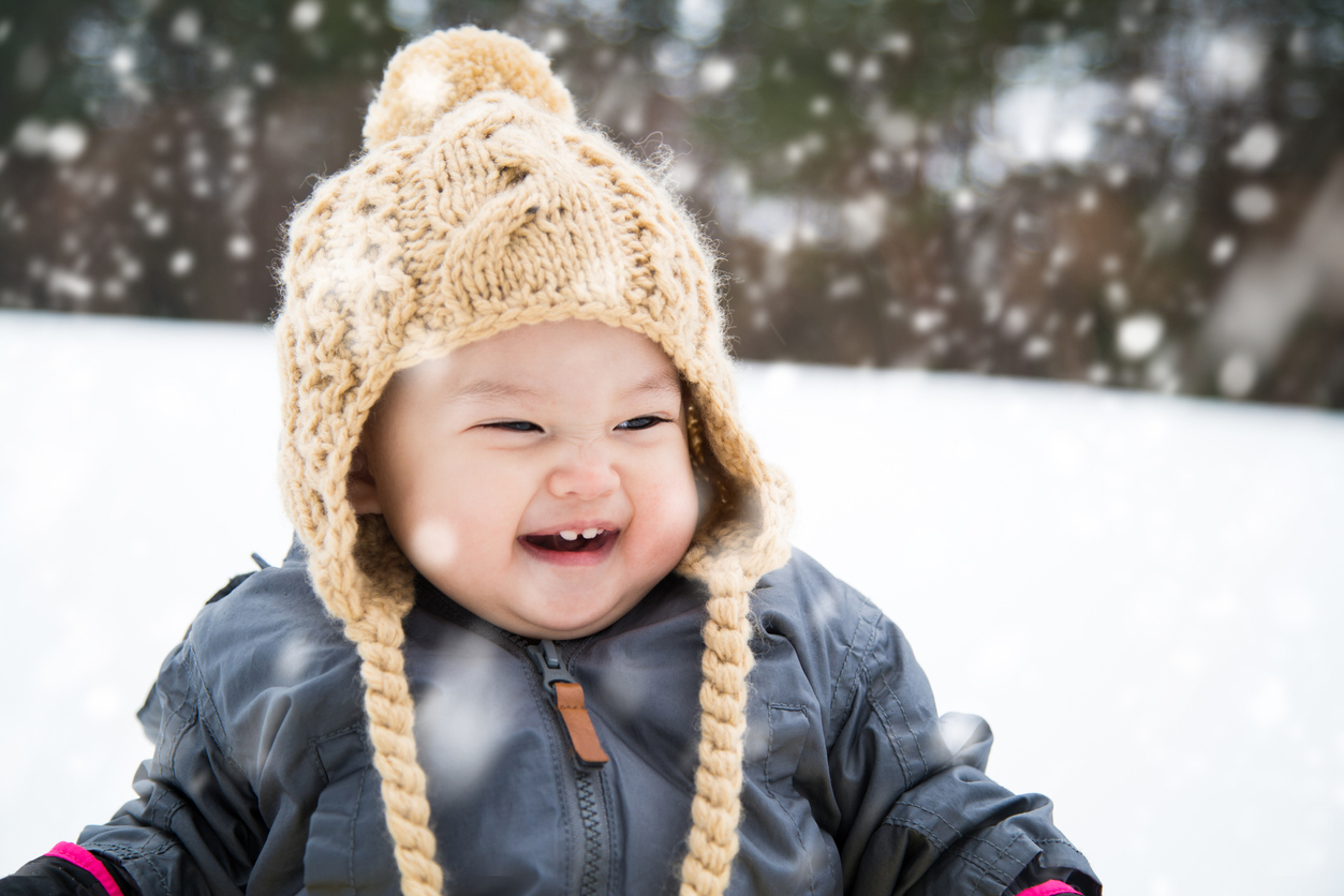 Baby playing outside in the snow