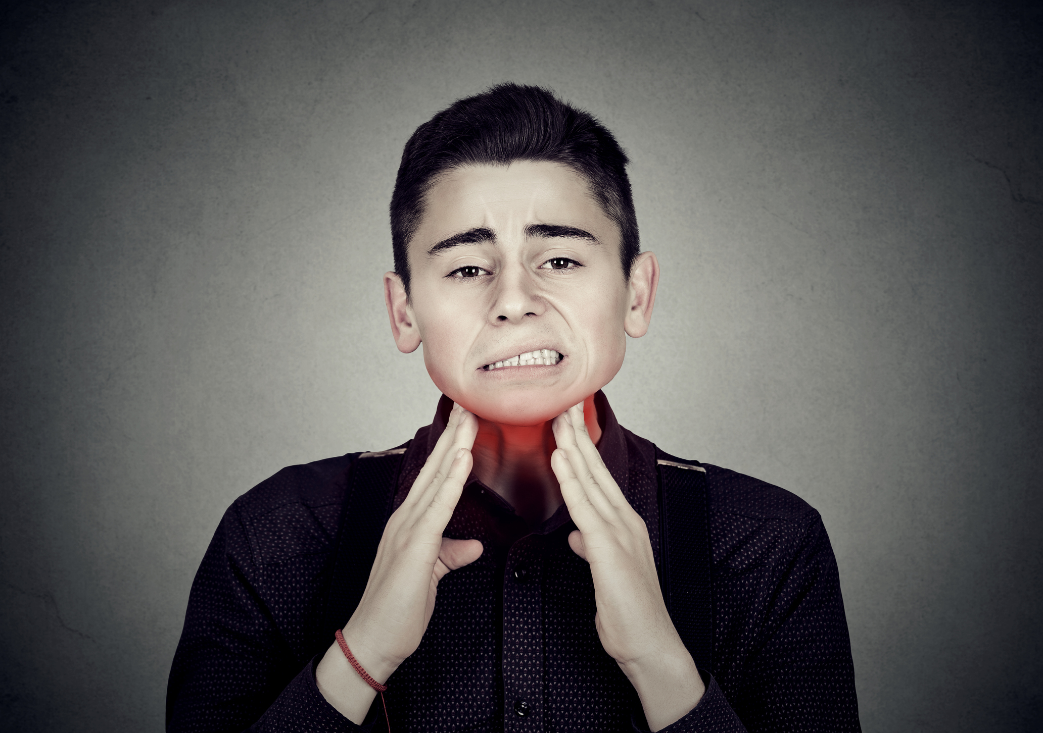 Man with sore throat irritation touching neck colored in red