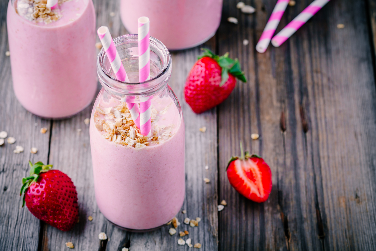 Strawberry milkshake with granola in glass