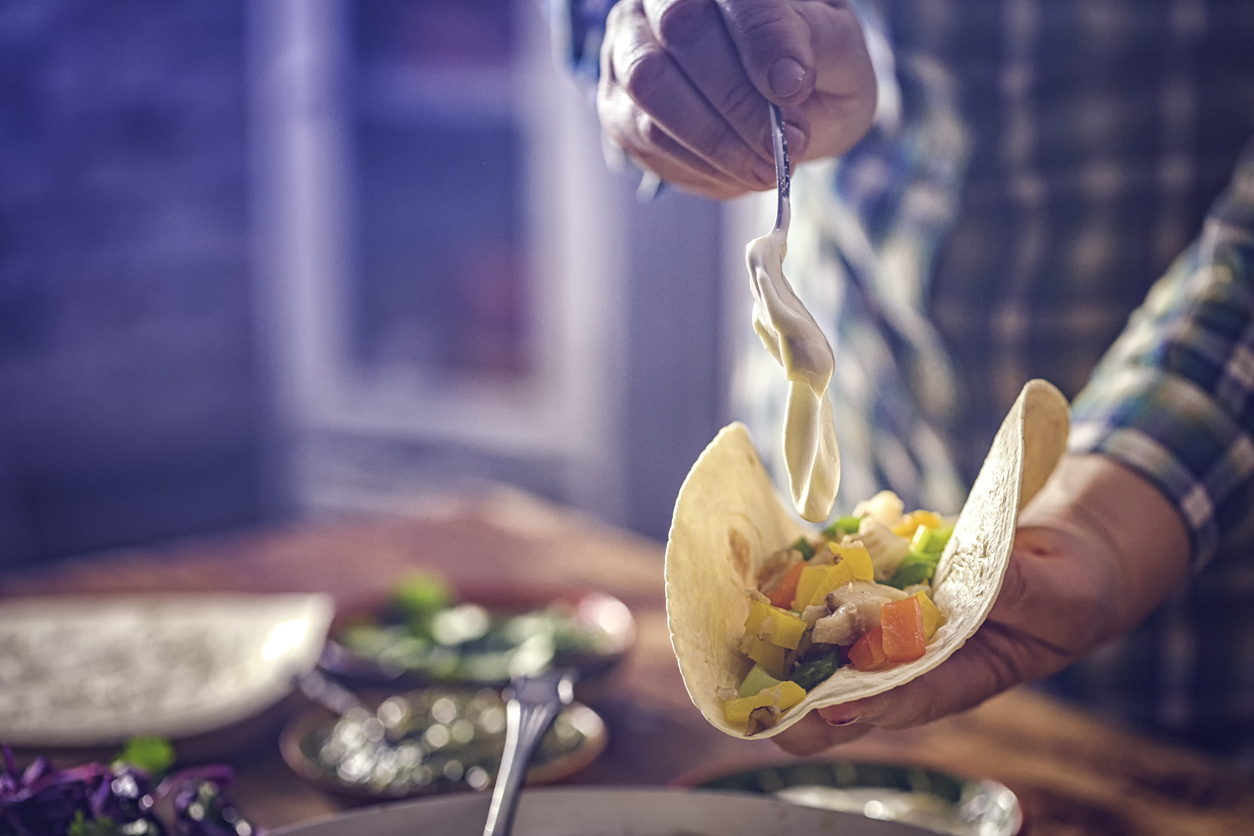 Preparing Mexican Tacos with Spicy Salsa and Shrimps