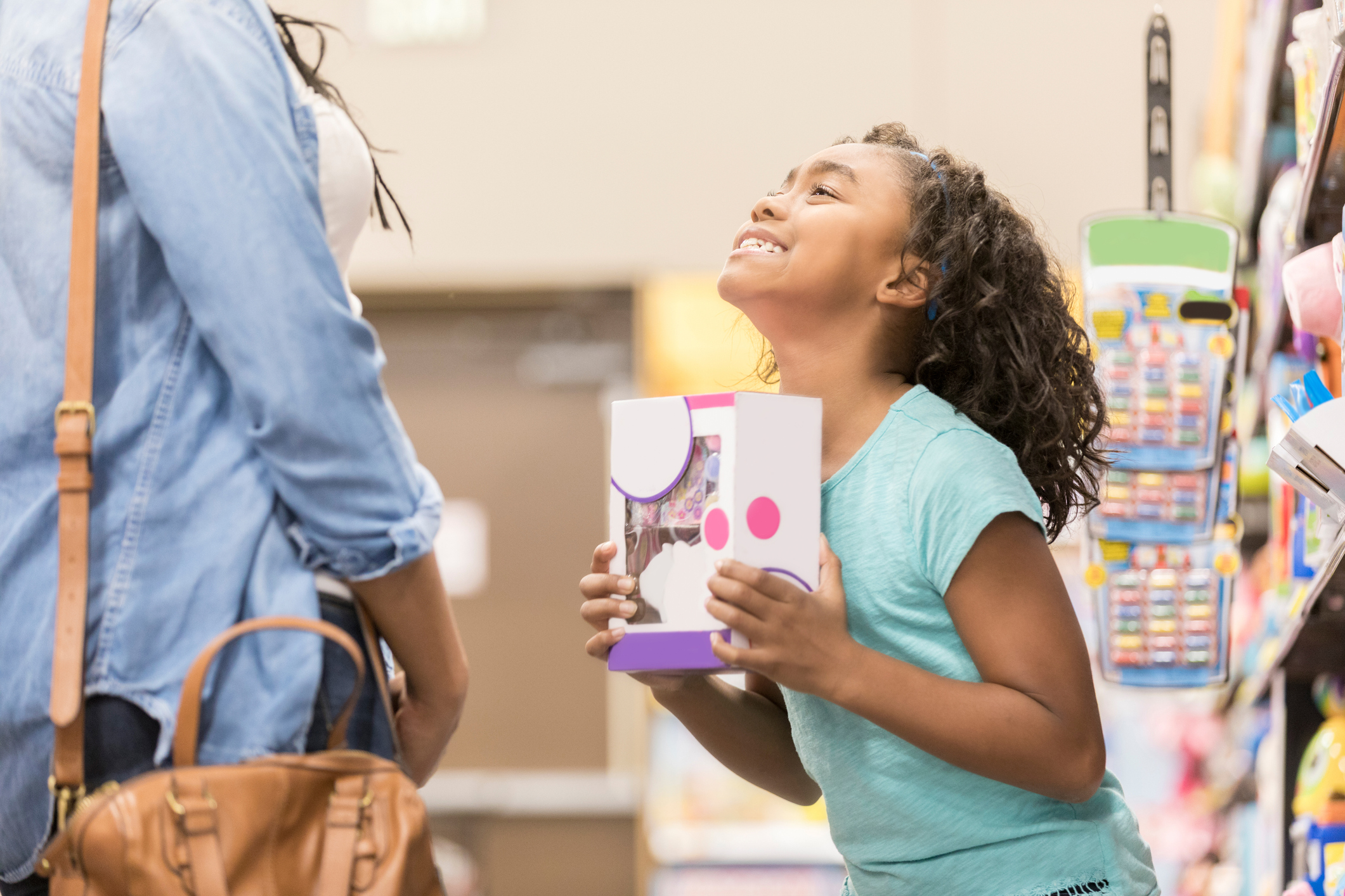 Little girl begs her mom to buy a toy