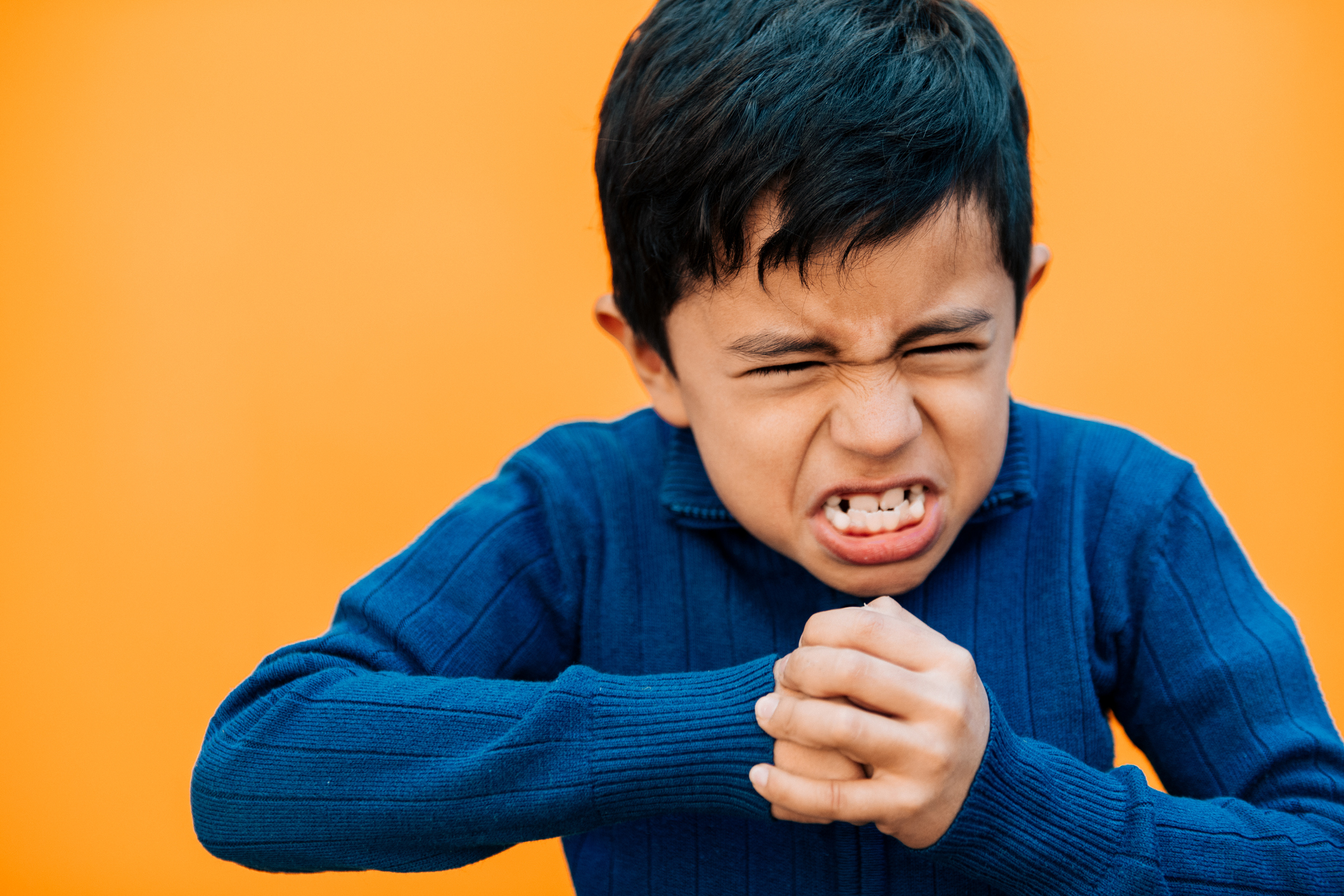 Angry Little boy making a fist