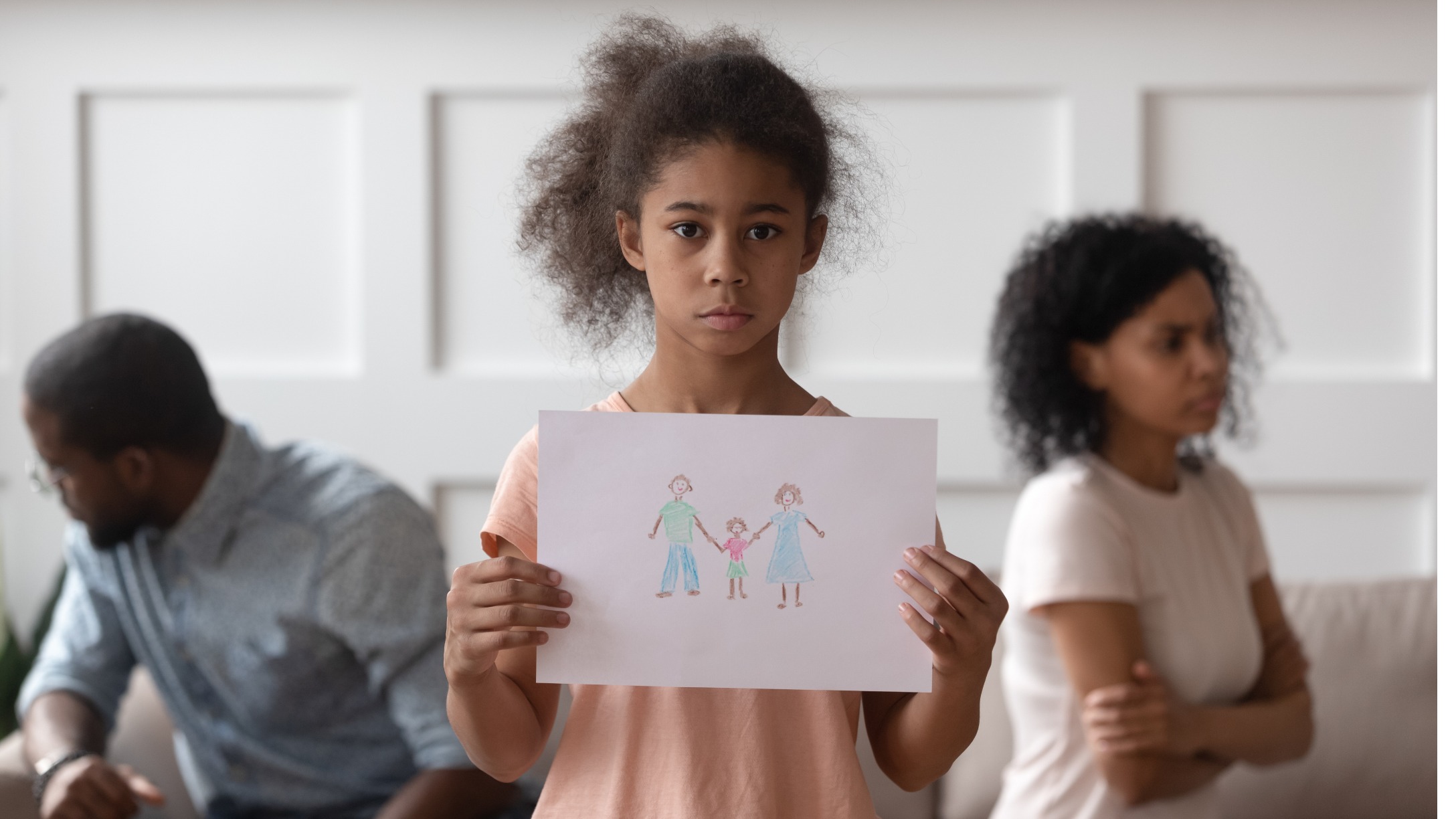 stressed-small-girl-holding-picture-with-happy-family-picture-id1199968745.jpg