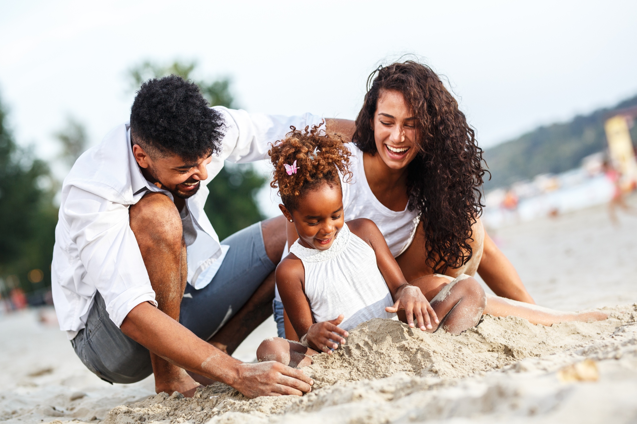 family at beach social distancing