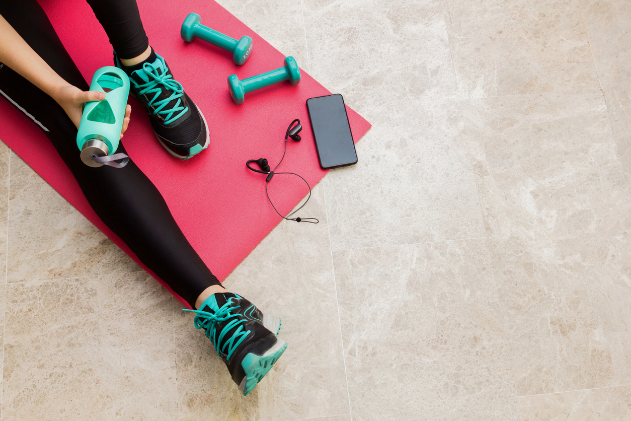 Stock photo of a young woman resting after exercising at home