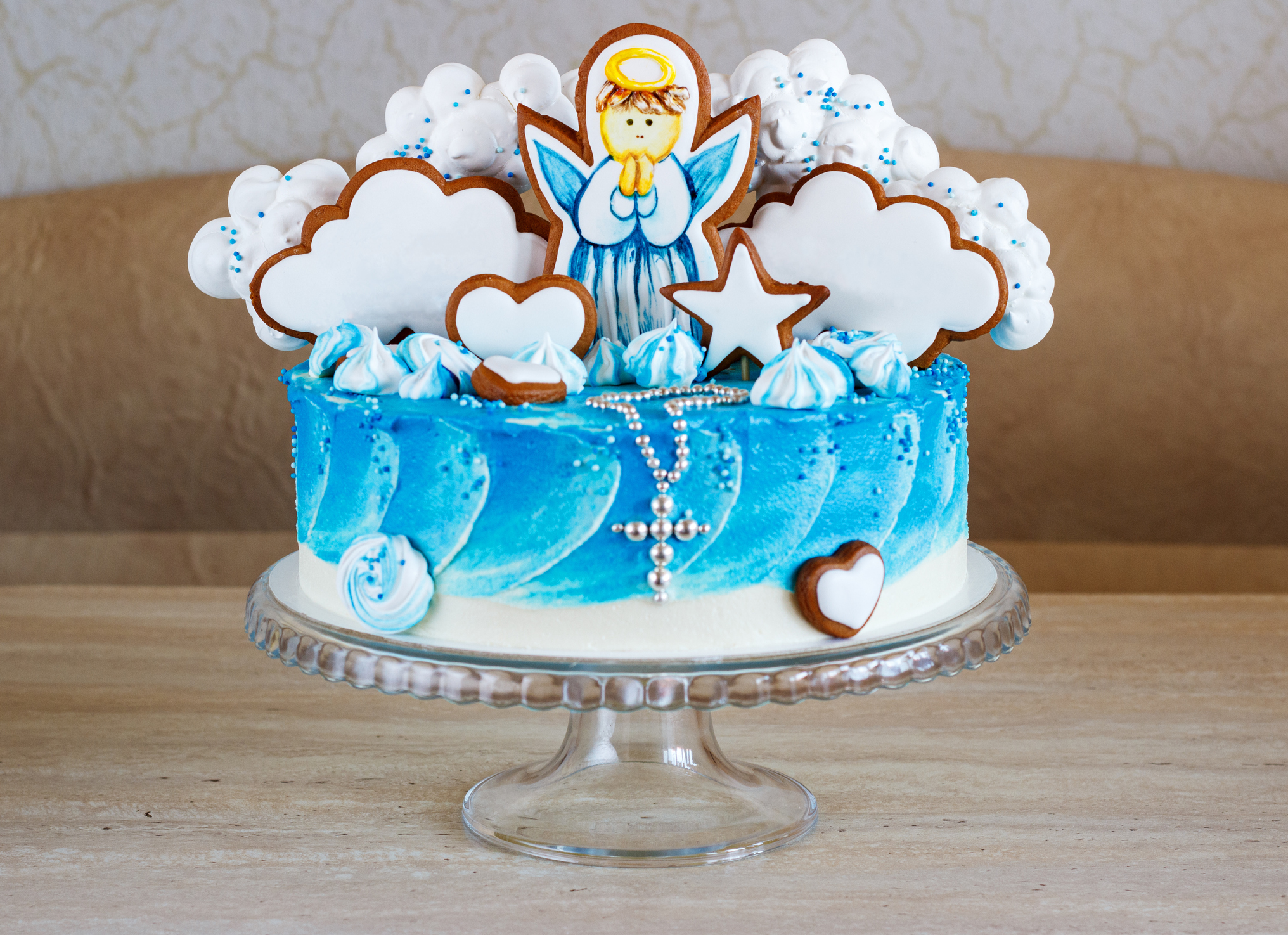 blue baptism cake with an angel on a gingerbread