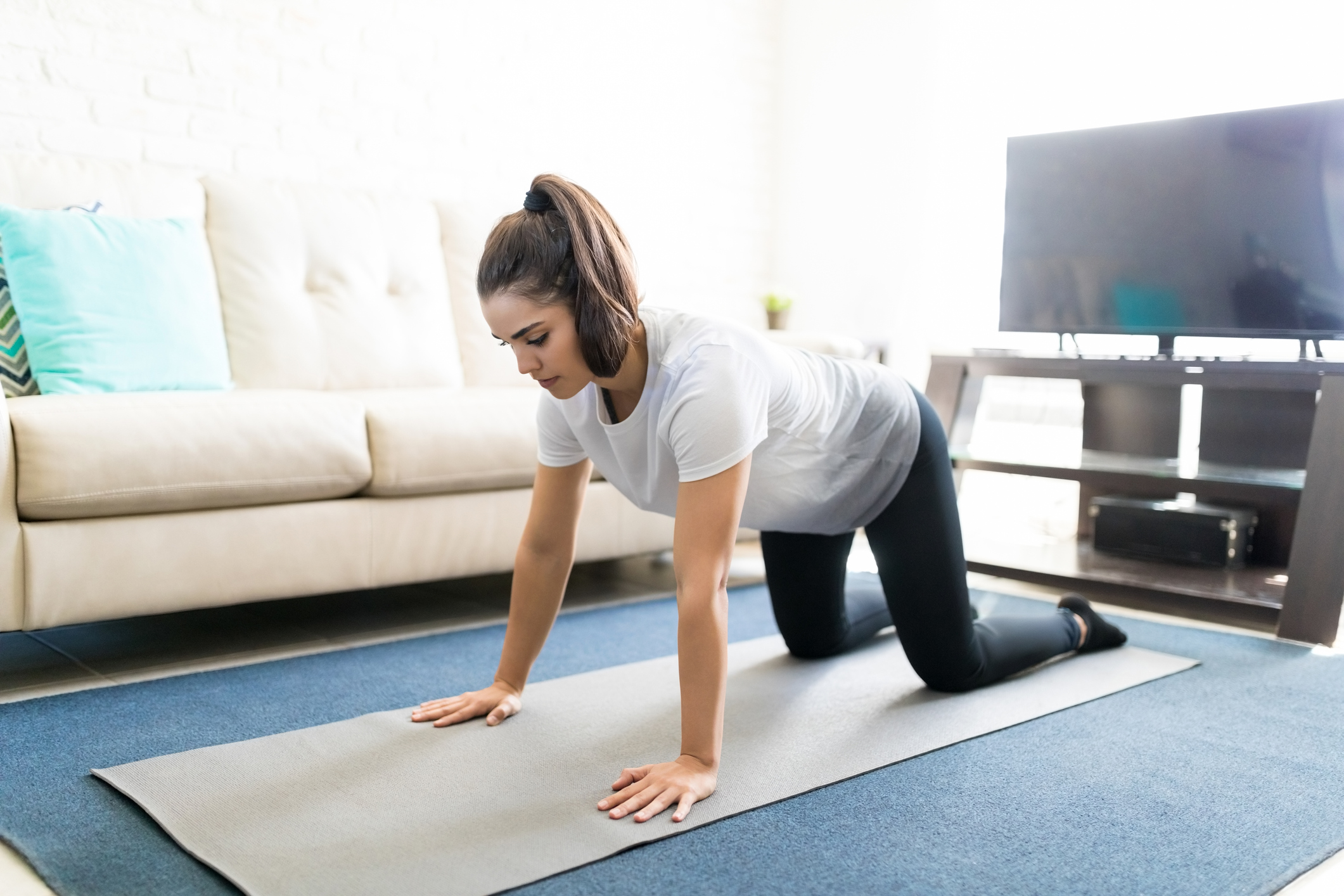 Healthy woman exercising at home