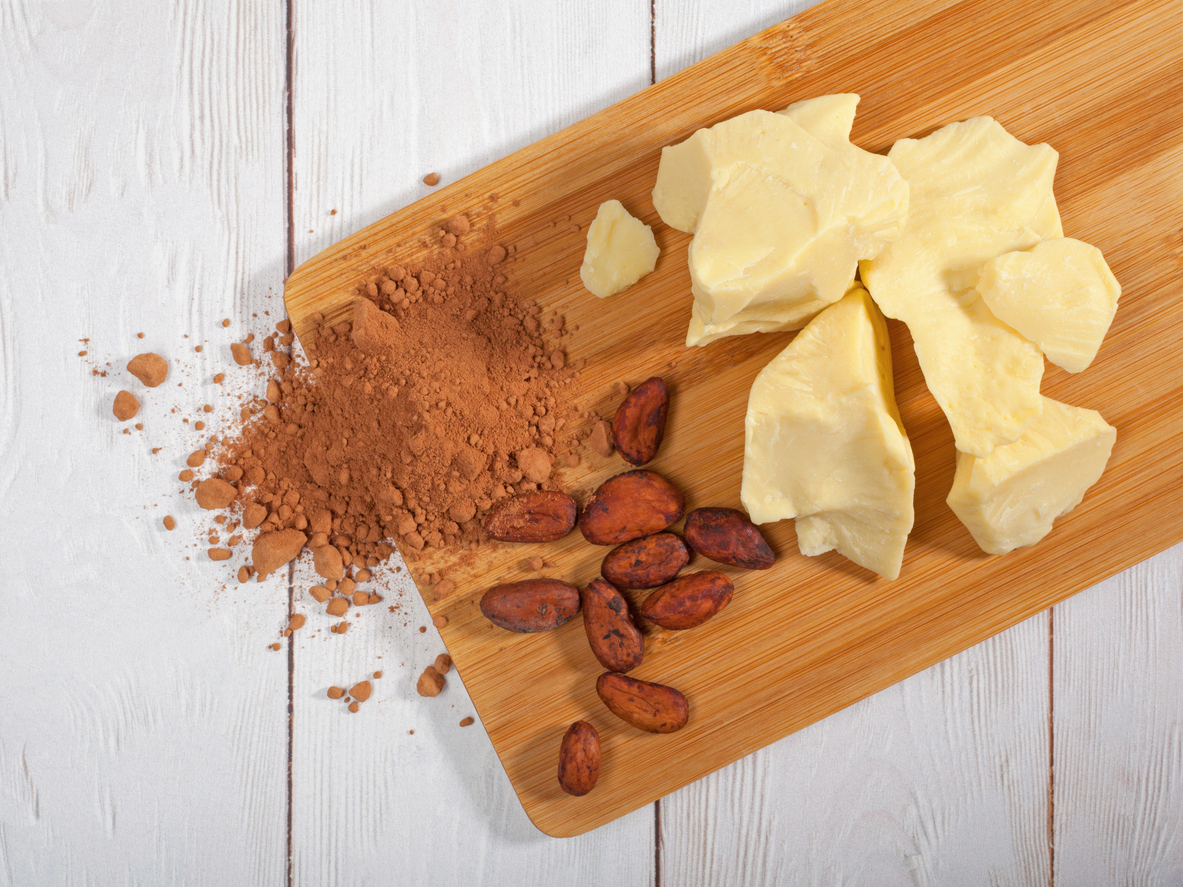 Pieces of natural cocoa butter, cocoa powder and cocoa beans