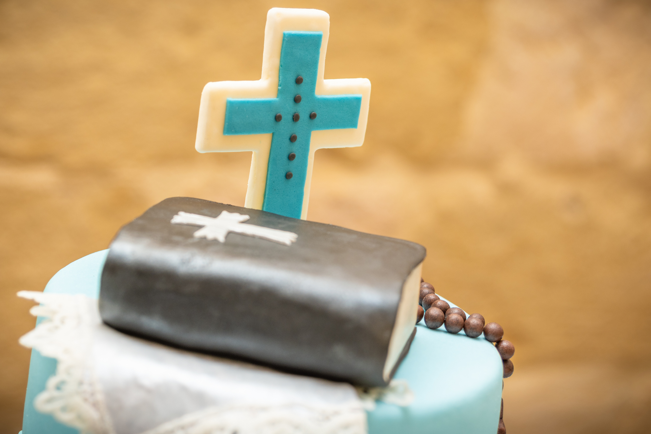 Holy Communion Cake decorated with bible and cross icing on top