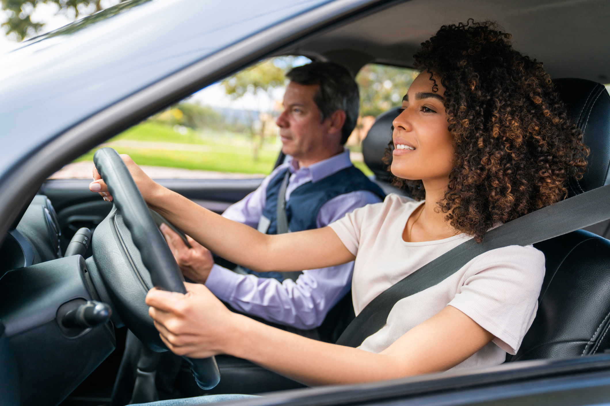 Woman driving, man in passenger seat