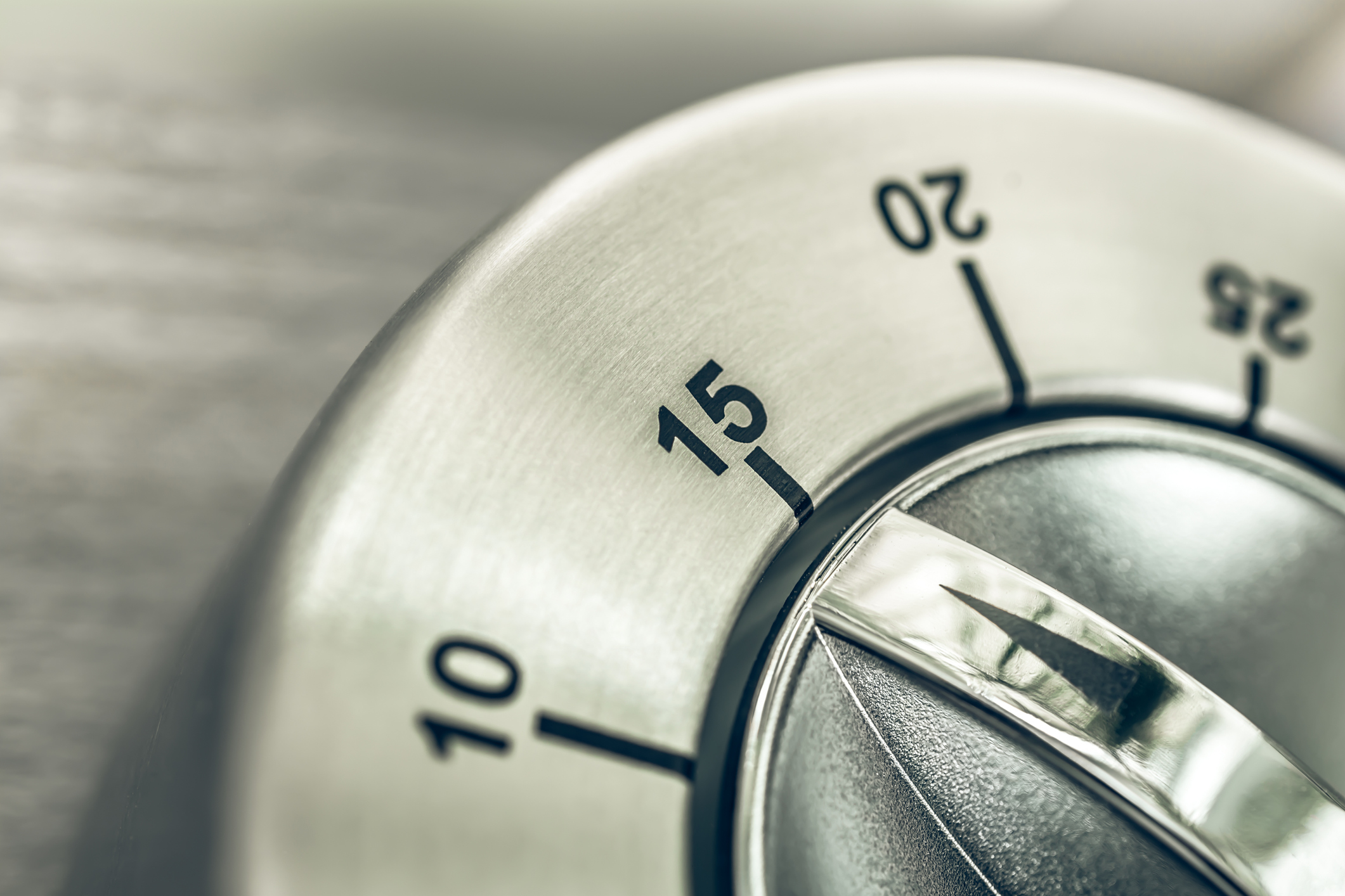 15 Minutes - Quarter Hour - Macro Of An Analog Chrome Kitchen Timer On Wooden Table