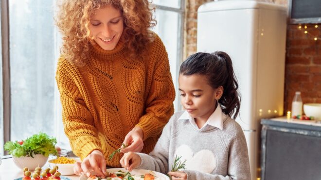 Mother and daughter making Thanksgiving appetizer