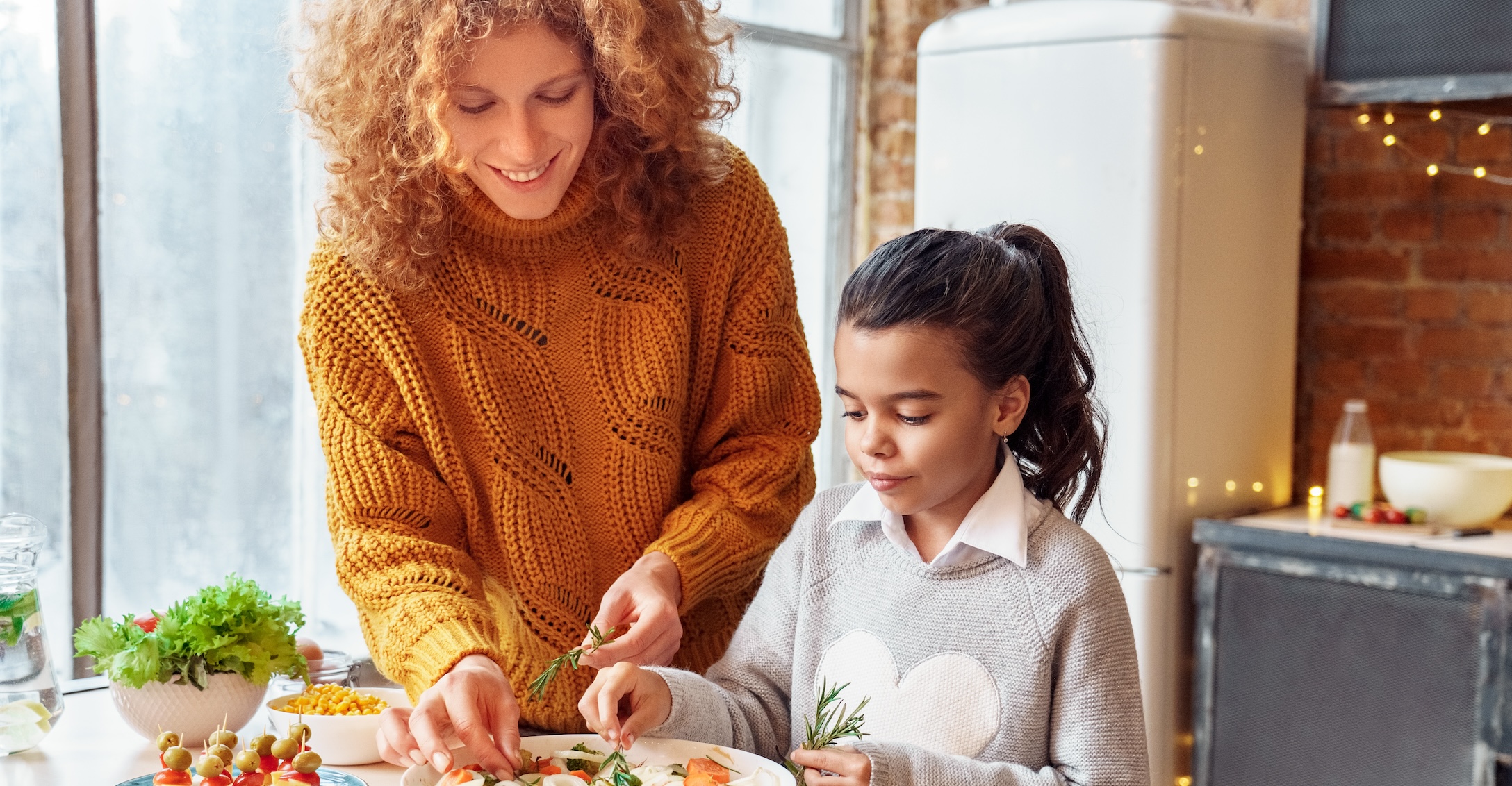 Mother and daughter making Thanksgiving appetizer