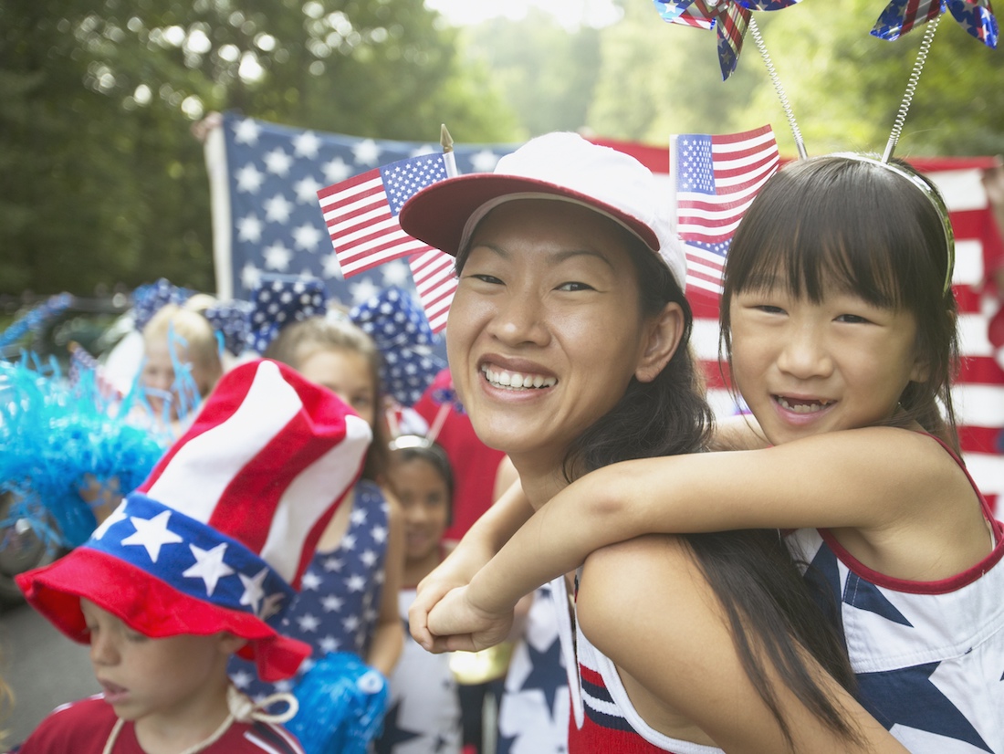 Asian mother and daughter in Fourth of July parade