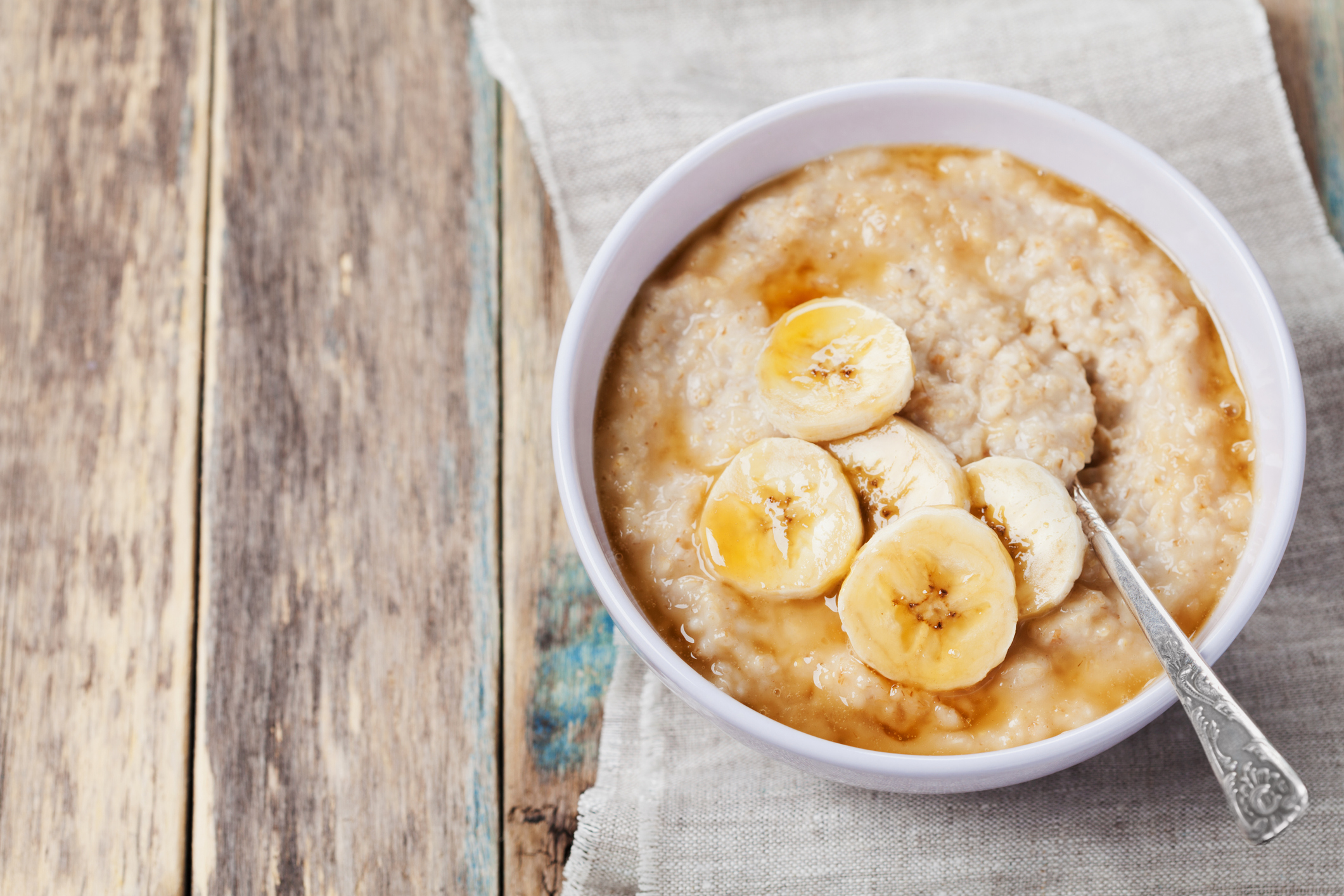 Healthy breakfast, oatmeal porridge with banana with text copy space