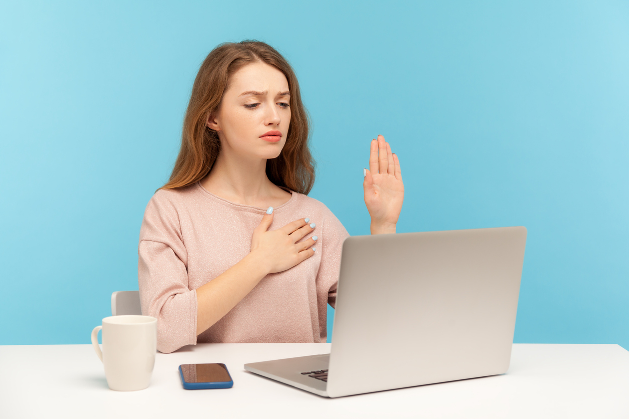 I swear! Honest responsible woman making loyalty promise oath and looking at laptop screen, talking on video call