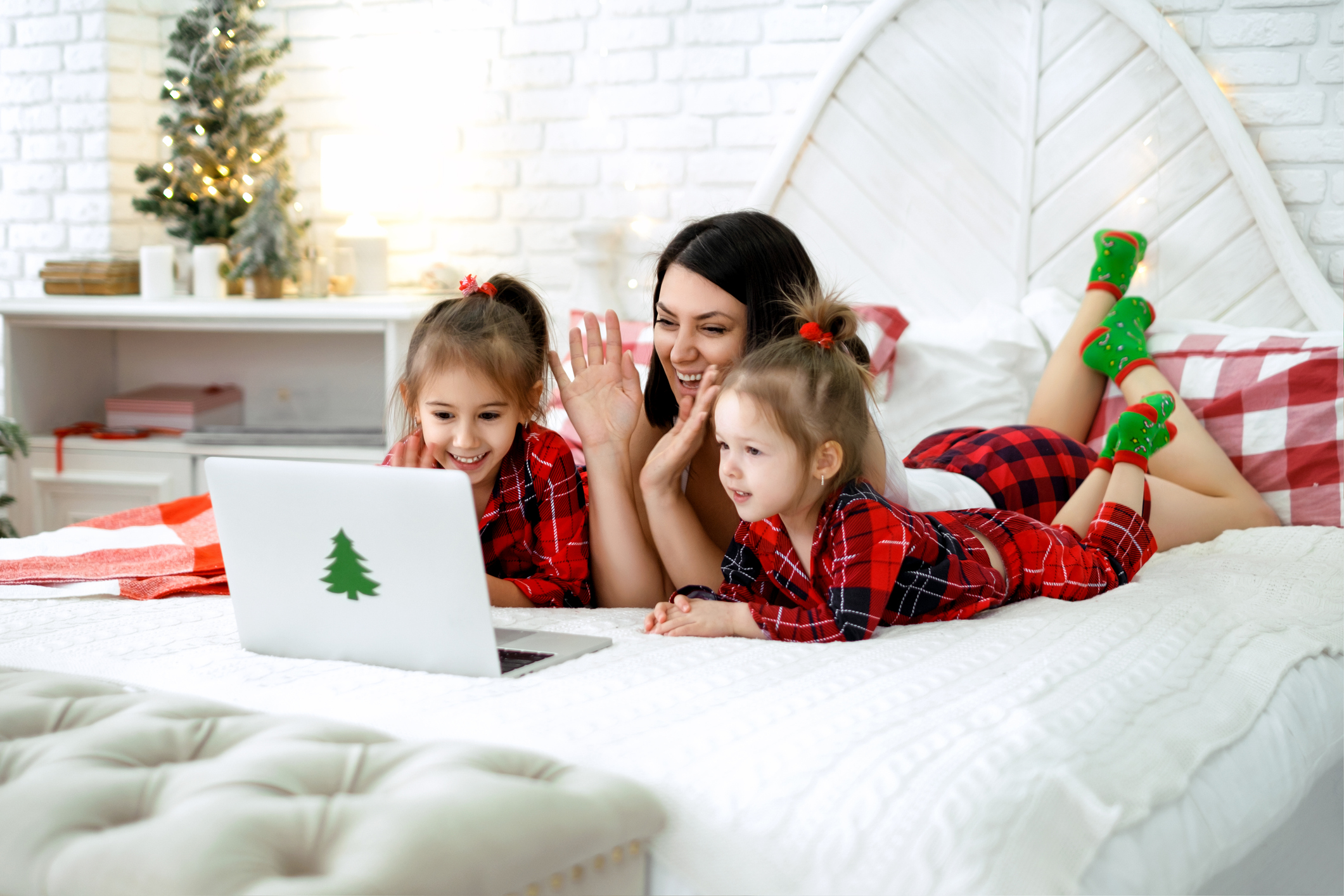 Kids with mother say hello, talking meeting relatives on video call at Xmas.