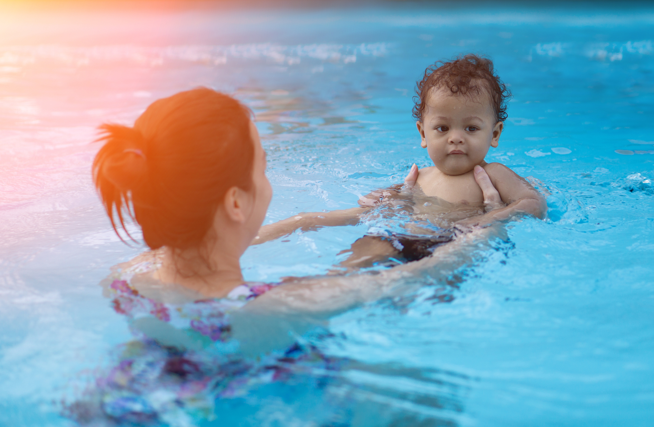 baby boy first time in a swimming pool