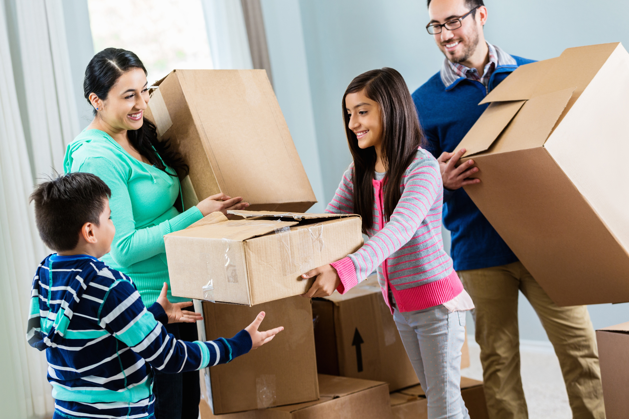 Happy family unpacks in their new home