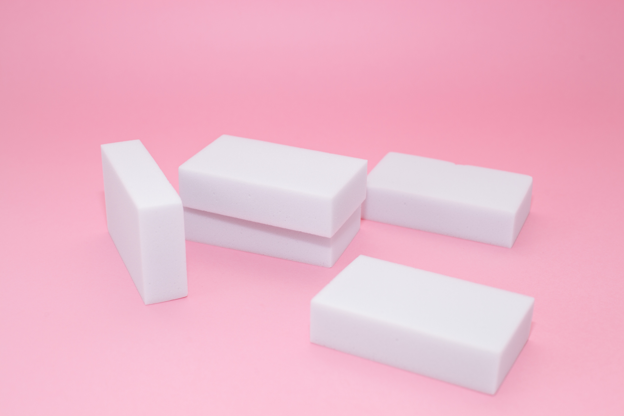 Melamine sponge stack on pink background