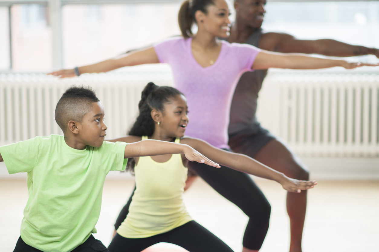 Family of Four Doing Yoga at the Gym