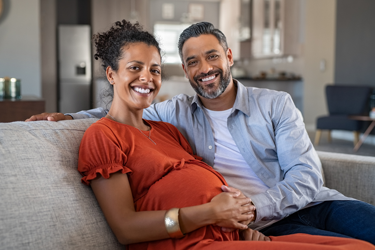 Pregnant african woman with husband at home