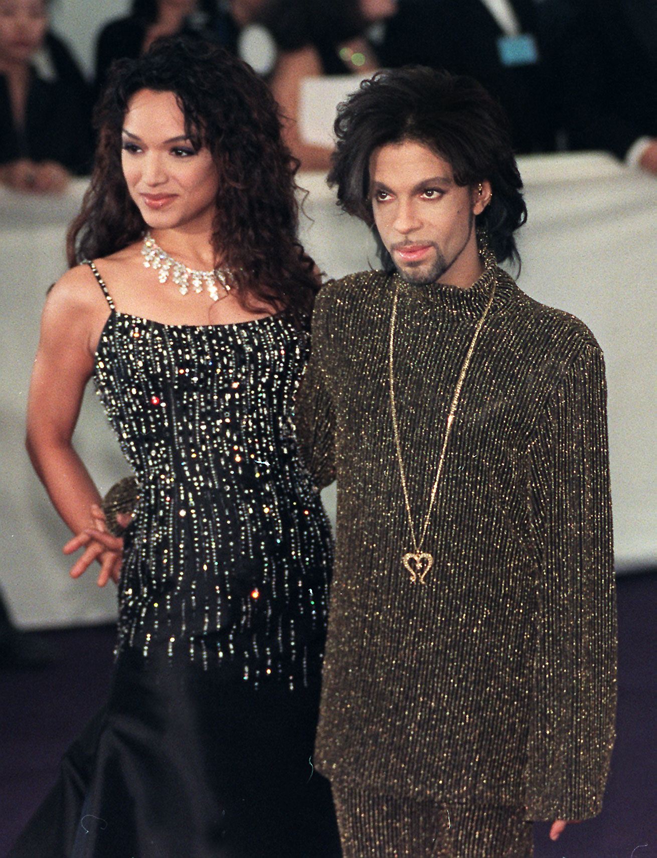 Prince poses for photographers with his wife Mayte