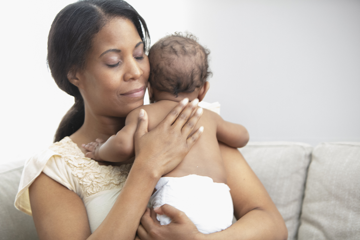 Mother holding her sleeping daughter