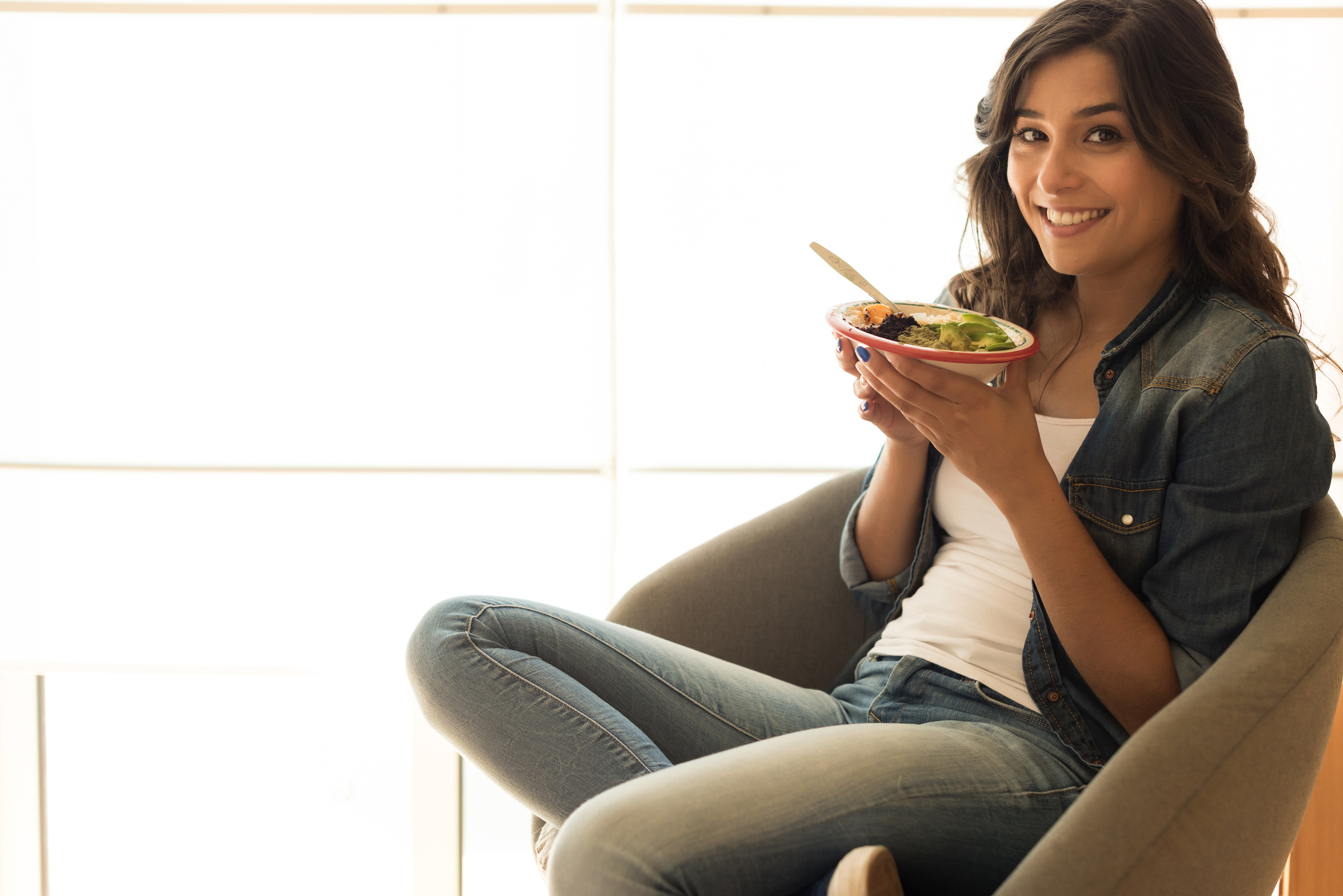 Woman eating a healthy bowl of superfoods