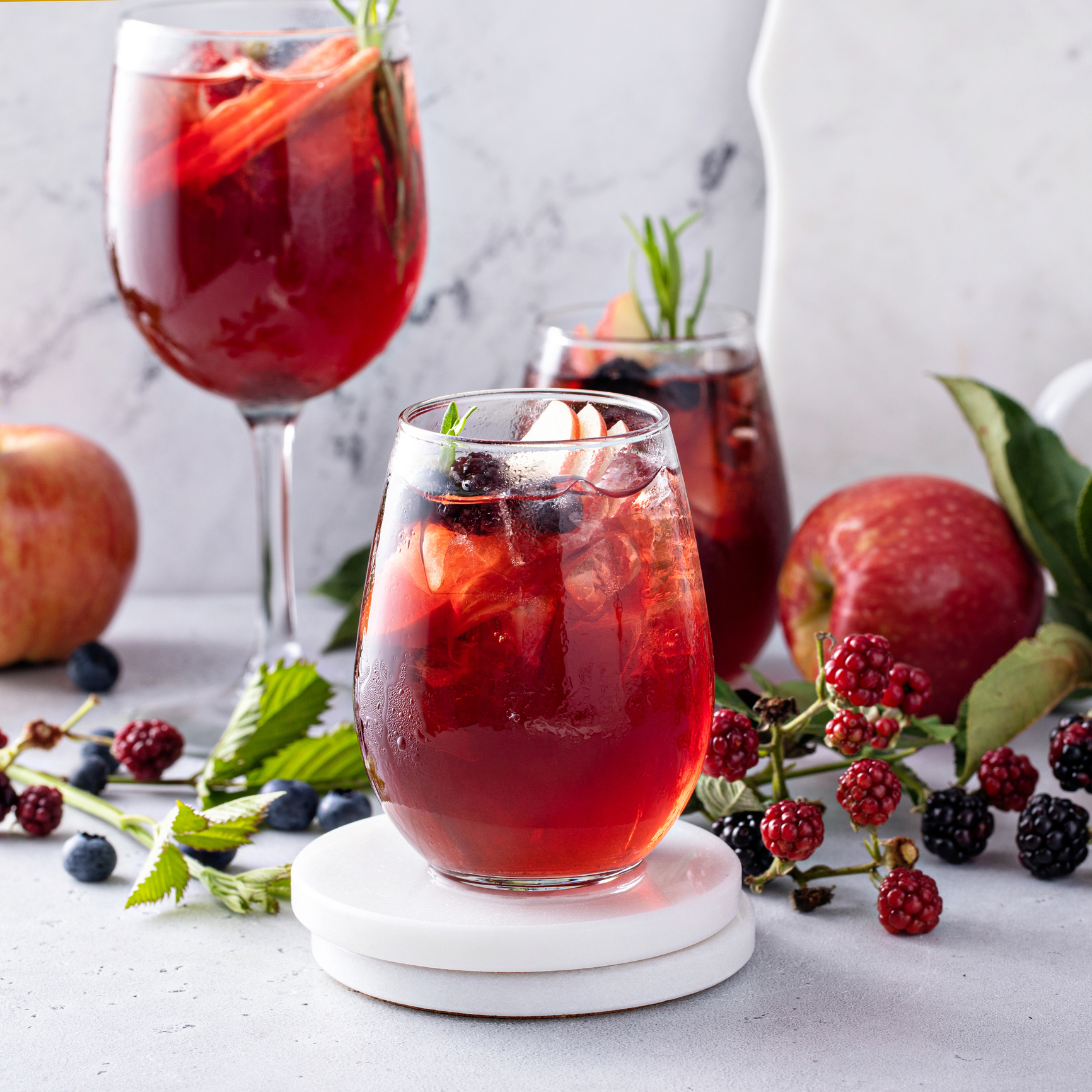 Fall berry and apple sangria in a glass with ice