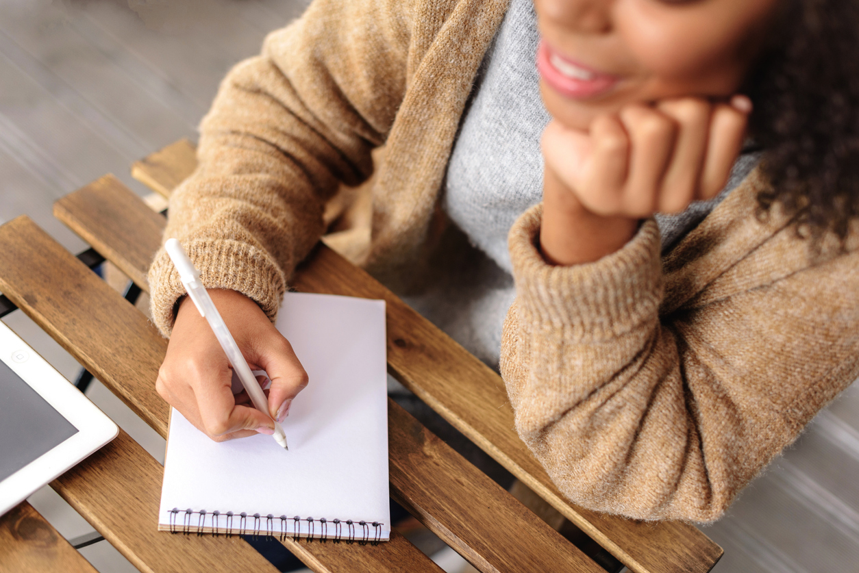 creative girl taking a notes in the notepad