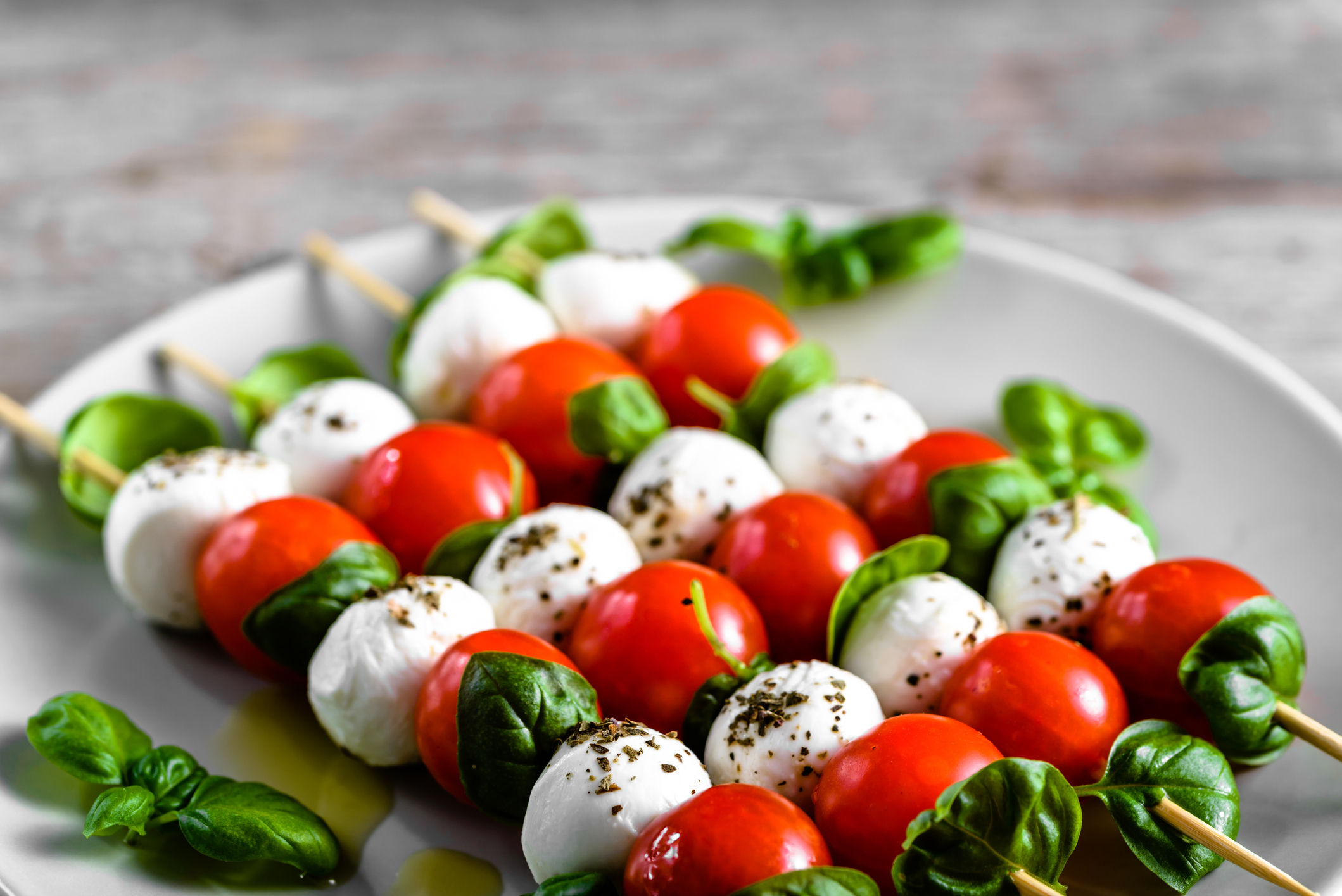 Healthy appetizer - caprese salad with tomato and mozzarella, italian food of mediterranean diet with olive oil dressing, weight loss concept