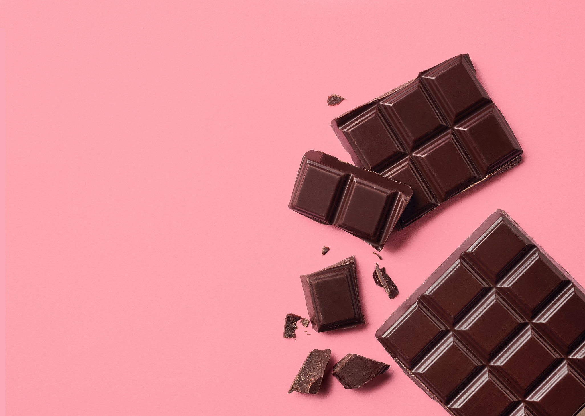 Dark chocolate on pink background