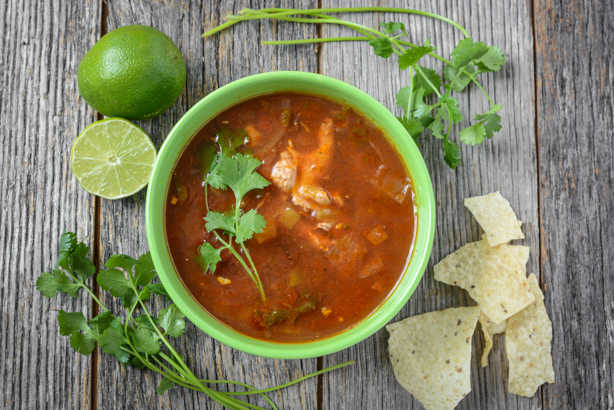 Tortilla Soup with Cheese, Lime, Cilantro and Wooden Spoon