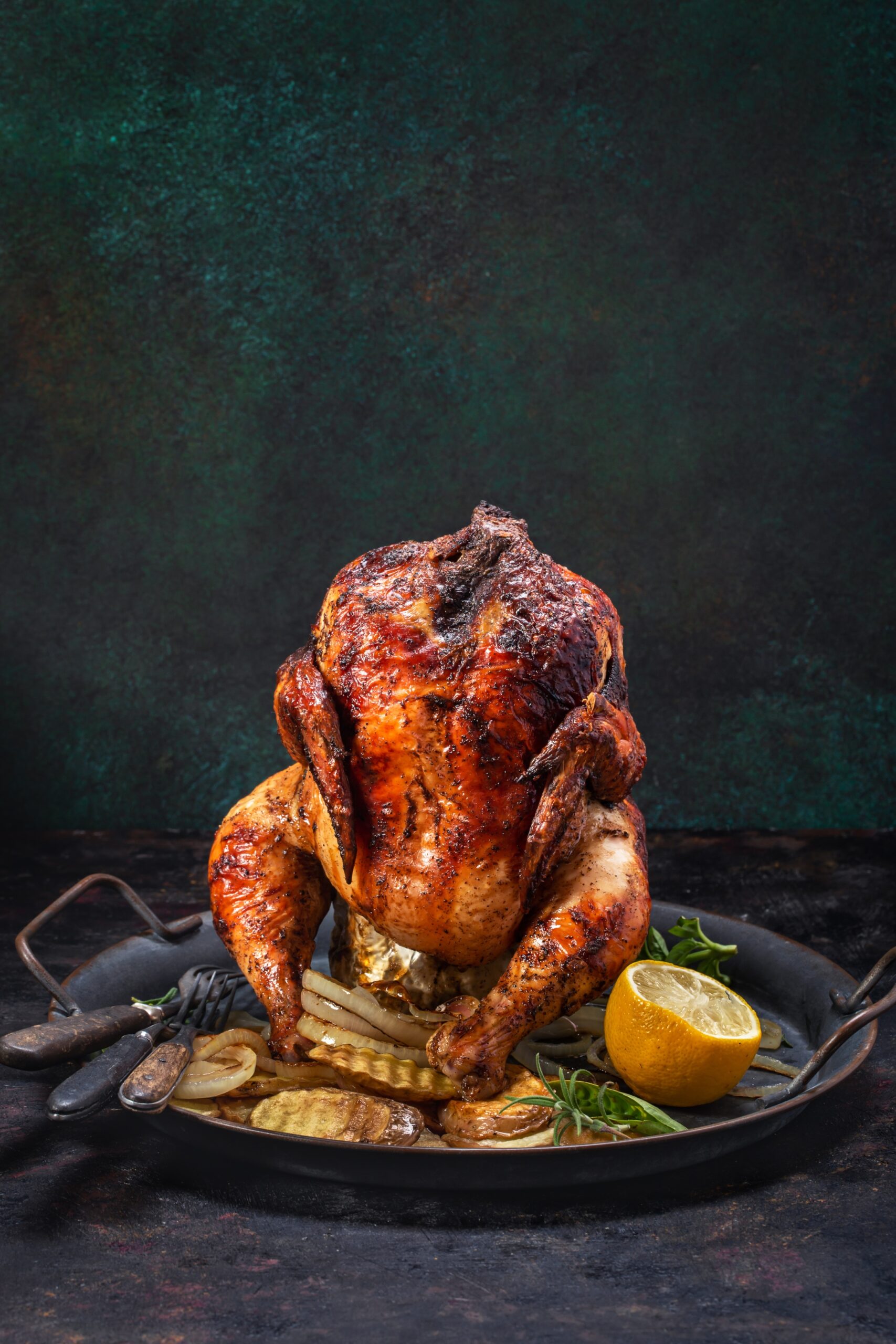 Grilled beer can chicken and vegetables on tray