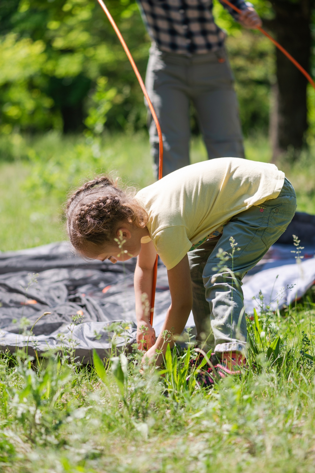 Baby girl make sleeping place during camping outdoors