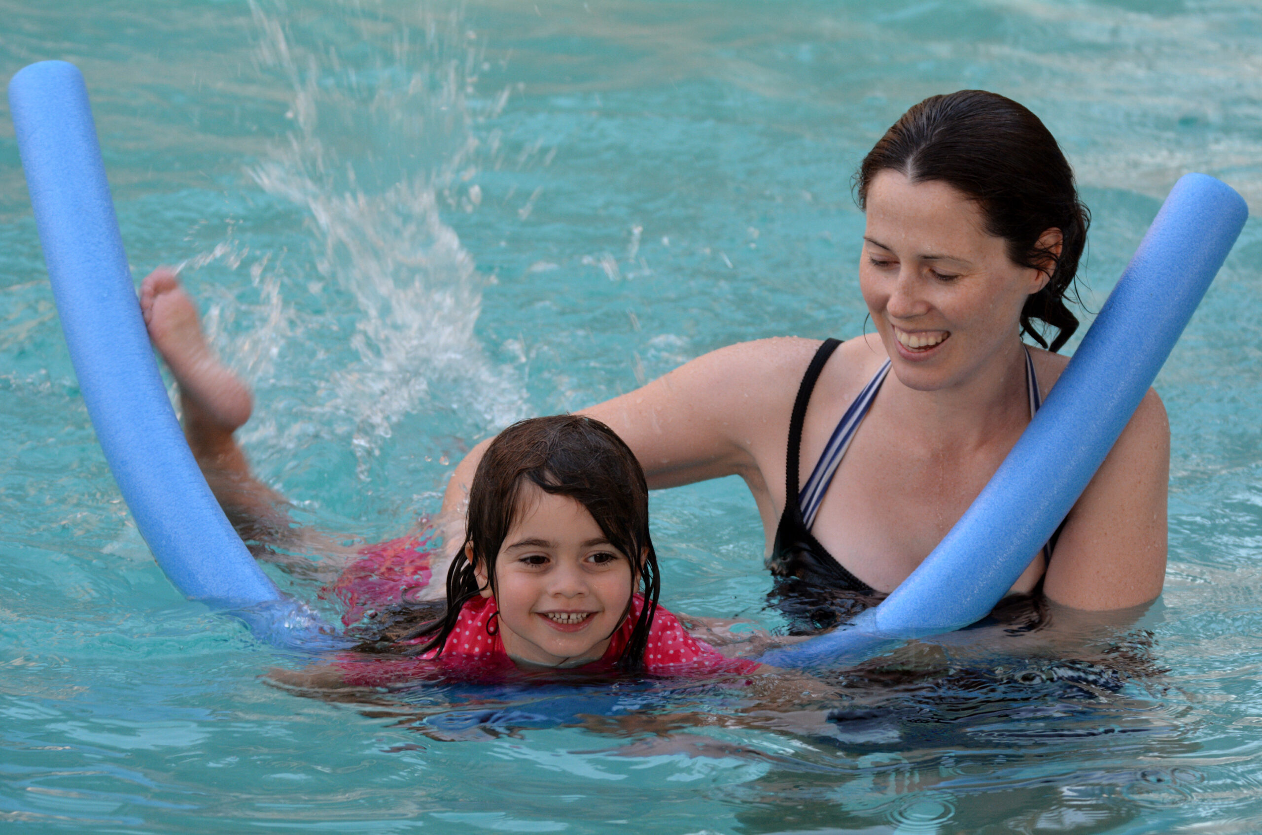 Mother teaches her child to swim