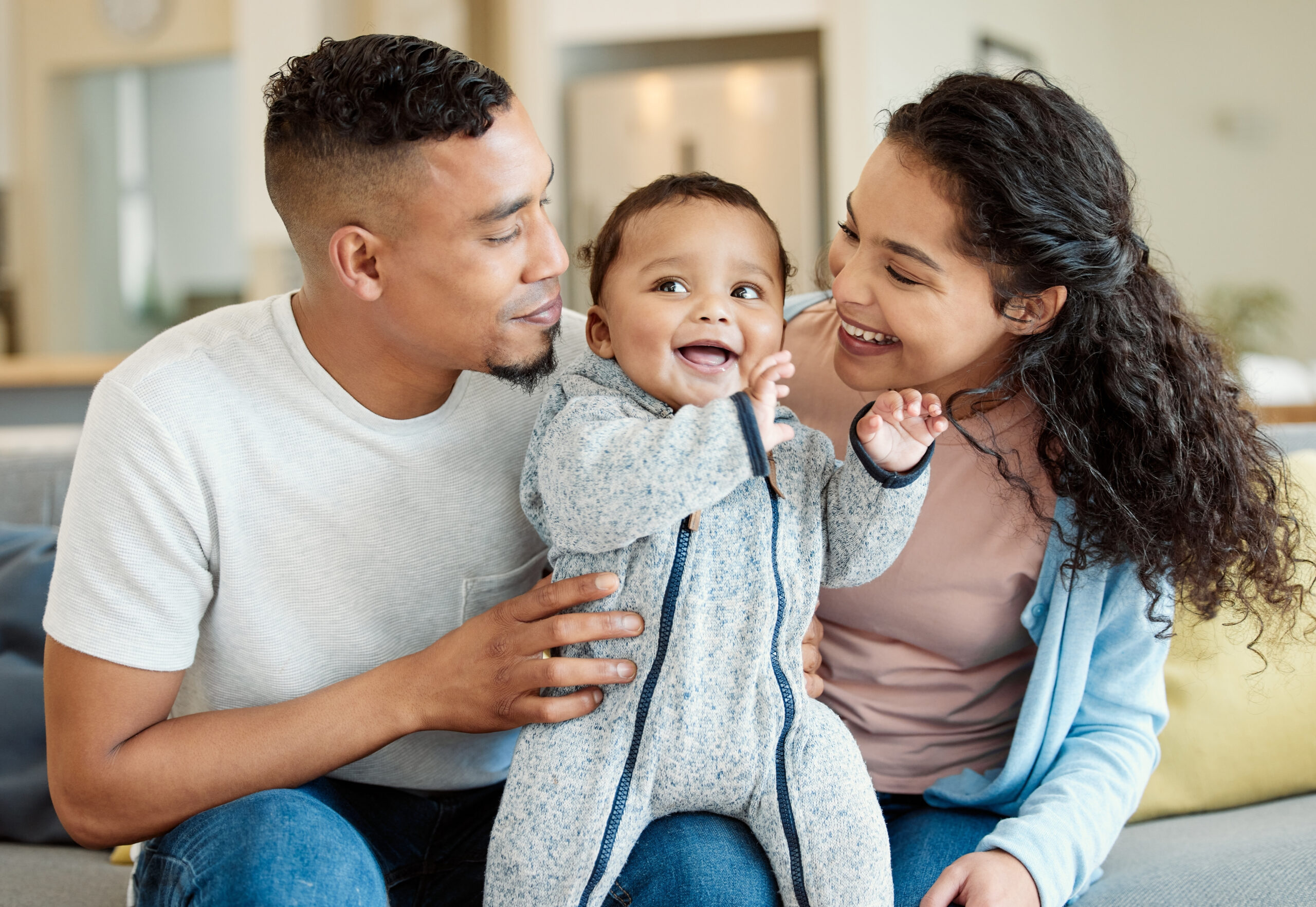 Shot of a young family bonding with their baby boy at home