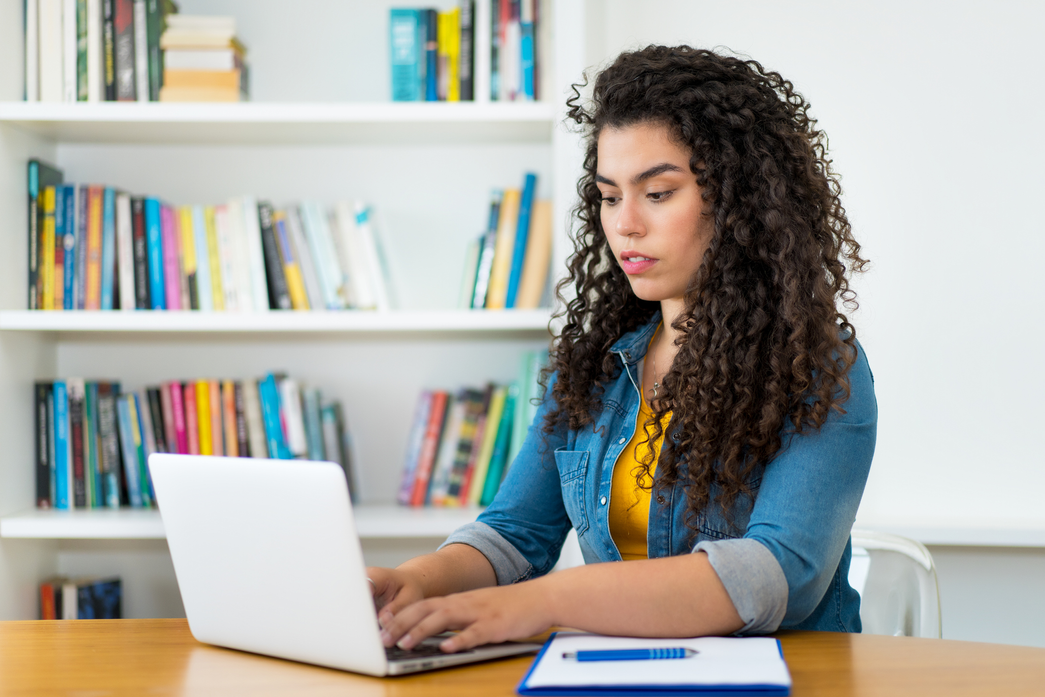 Beautiful latin american woman in quarantine at computer