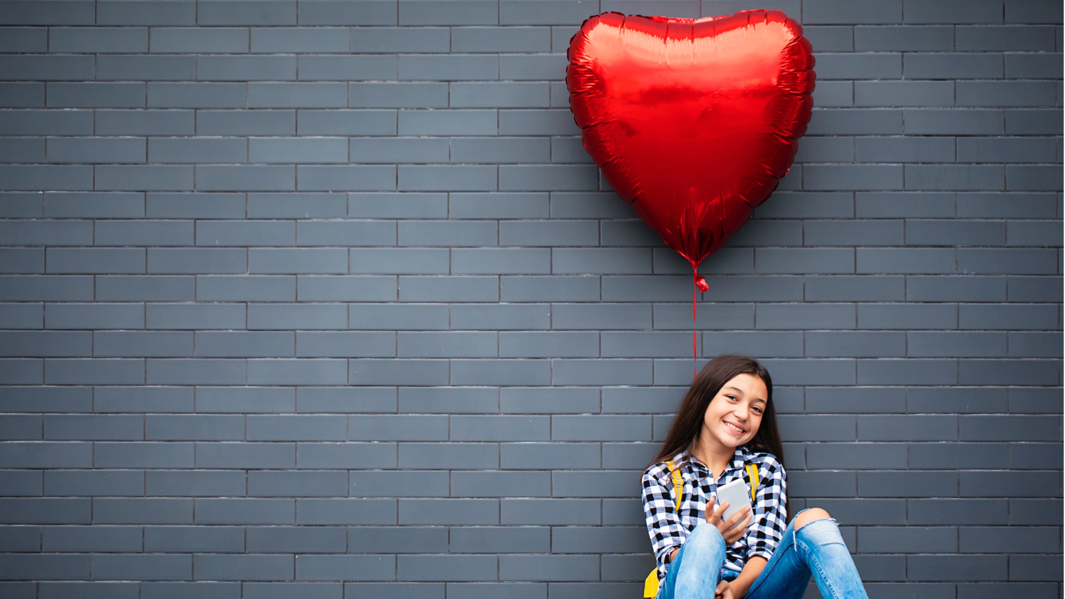 girl-with-heart-shape-air-balloon-picture-id1031522080.jpg