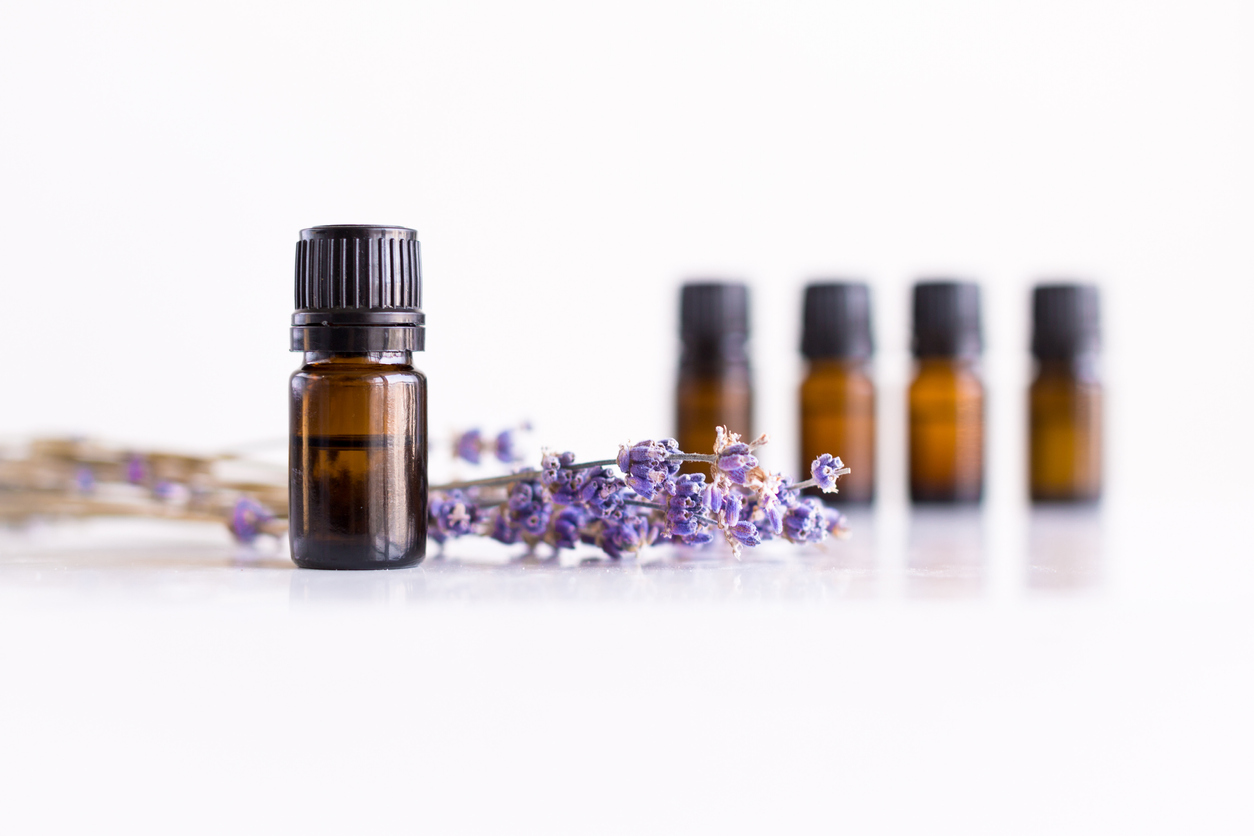 Essential oils in bottles. Lavender flowers decoration.