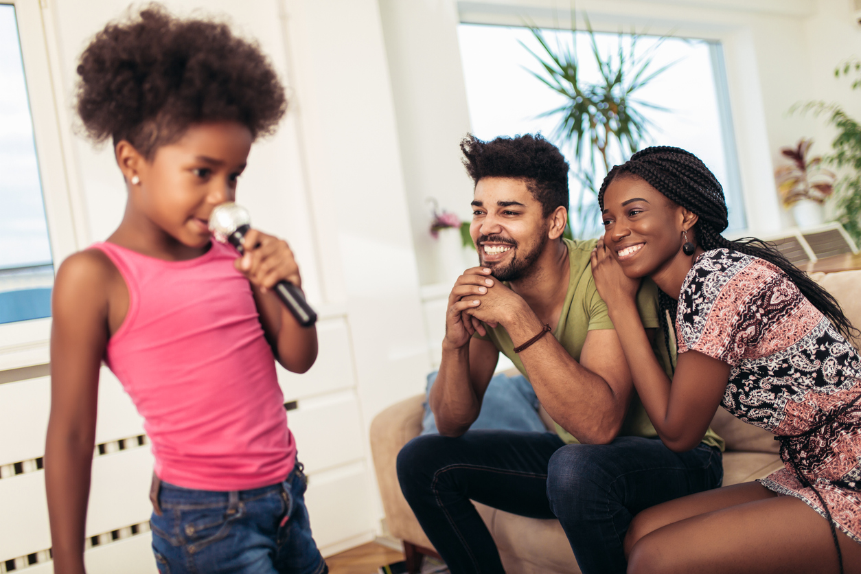 African american family enjoy singing karaoke at home