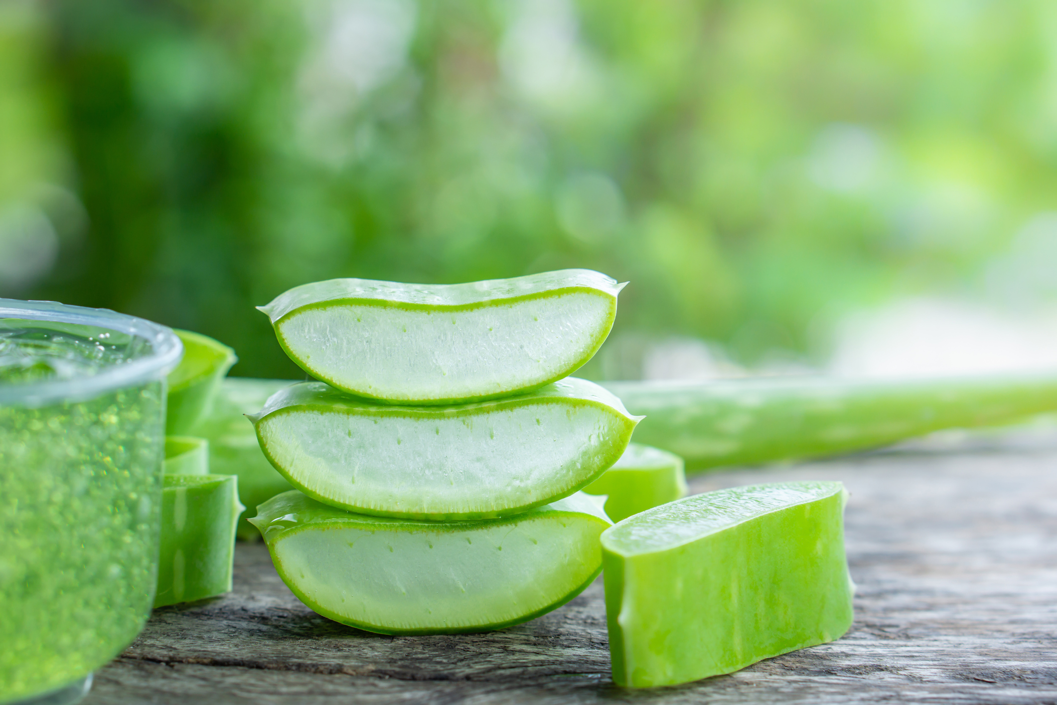 fresh aloe vera leaves slice and aloe vera gel on wooden table