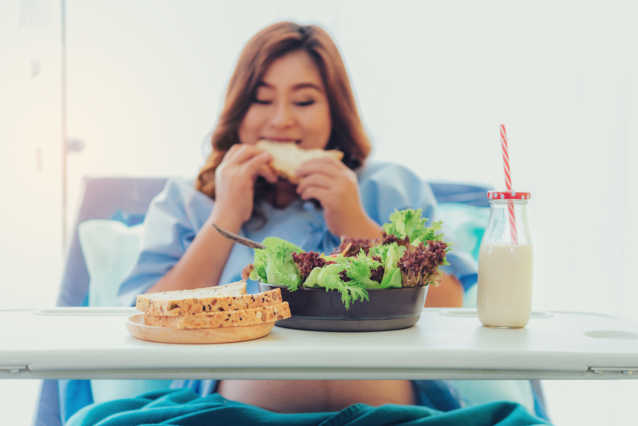 Pregnant woman eating bread, milk, fruits and vegetables, from relatives to visit.