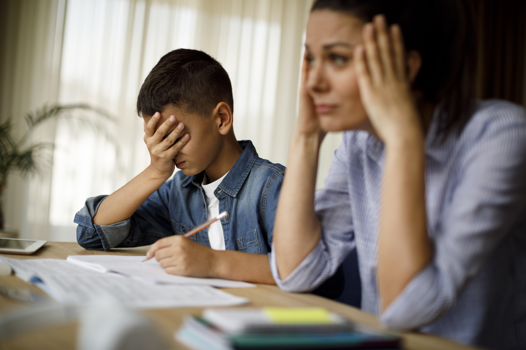 Teenage boy having problems in finishing homework