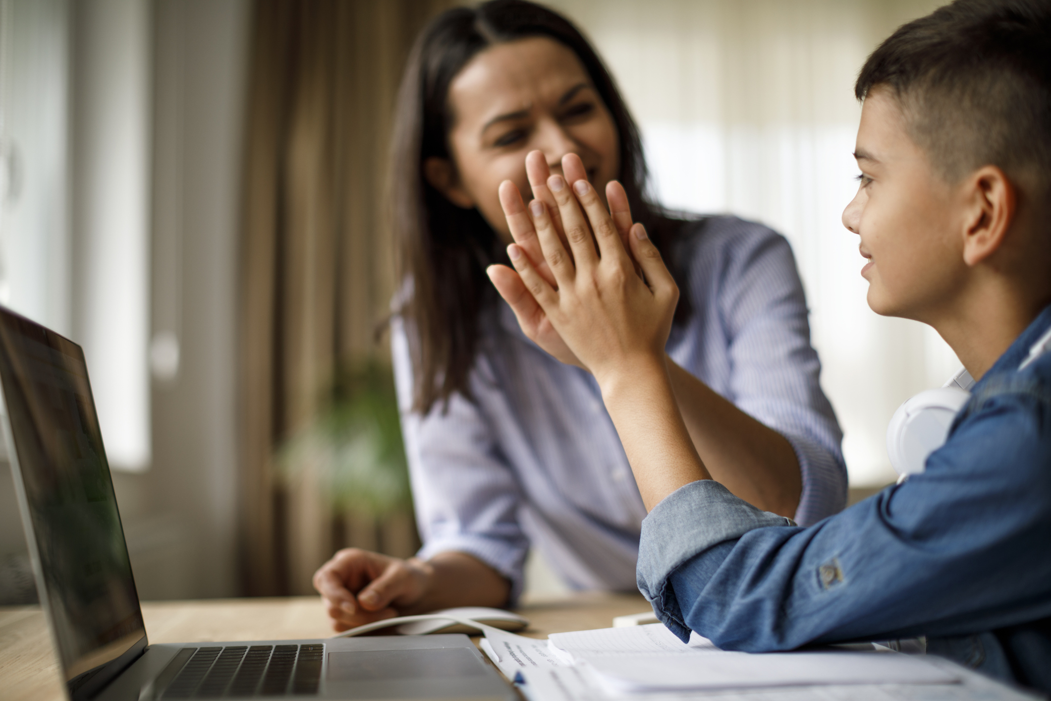 Mother giving high five to son