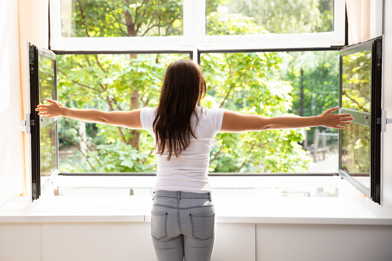 Rear View Of A Woman Outstretching Her Arms