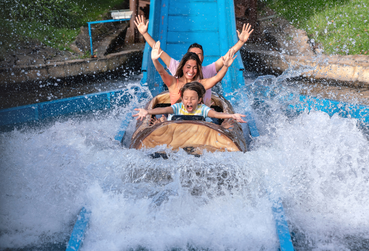 Happy family having fun in an amusement park