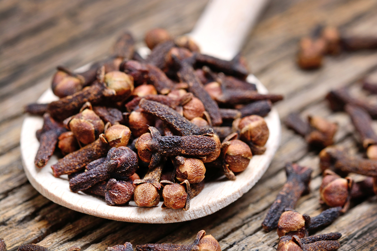 Clove in a wooden spoon on old table