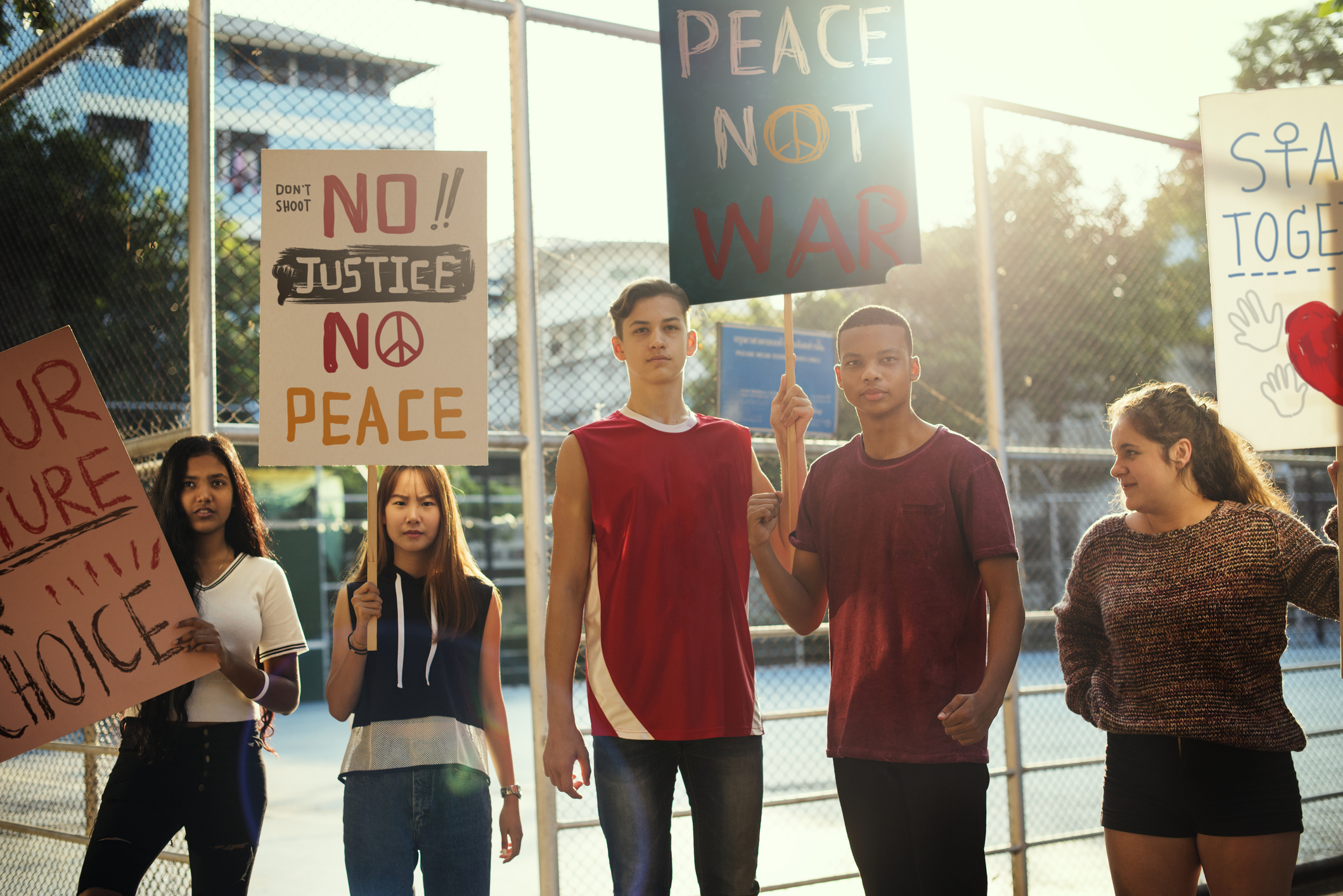 Group of teenagers protesting demonstration holding posters antiwar justice peace concept